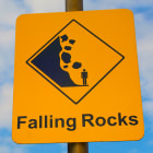 How can we protect a mountain town from falling rocks?