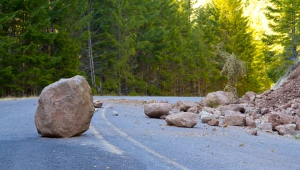 How can we protect a mountain town from falling rocks?