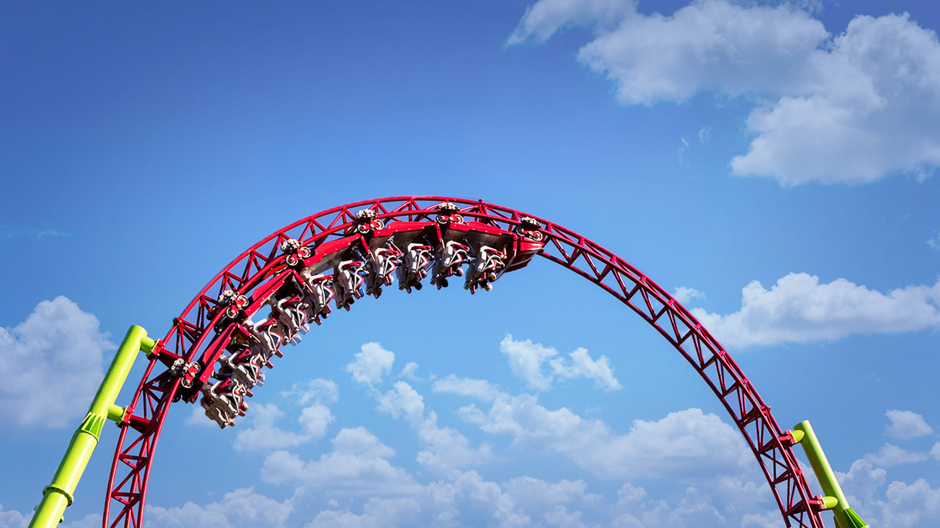 Why don't people fall out of roller coasters when they go upside down?